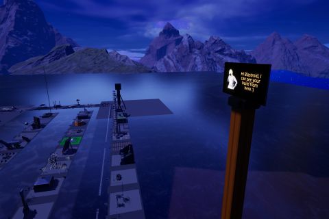 Image from the game Satisfactory featuring the view from the top of a pole sticking out of a gingerbread house (not visible in the shot). A sign atop the pole reads "Hi Blastroid, I can see your build from here :)". Off in the distance are many other contest entries in the Halloween 2023 Pass-It-On event.